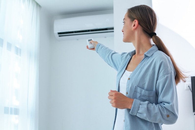 20230719122448 fpdl.in young woman adjusts temperature air conditioner using remote control room home 122732 935 medium